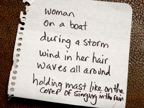 a woman, on a boat, during a storm, wind in her hair, waves all around, holding the mast and singing